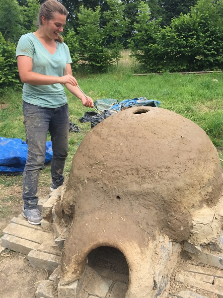 UCD MA in Archaeology student Maggie Kobik reconstructing a Minoan pottery kiln from Bronze Age Crete, at CEAMC